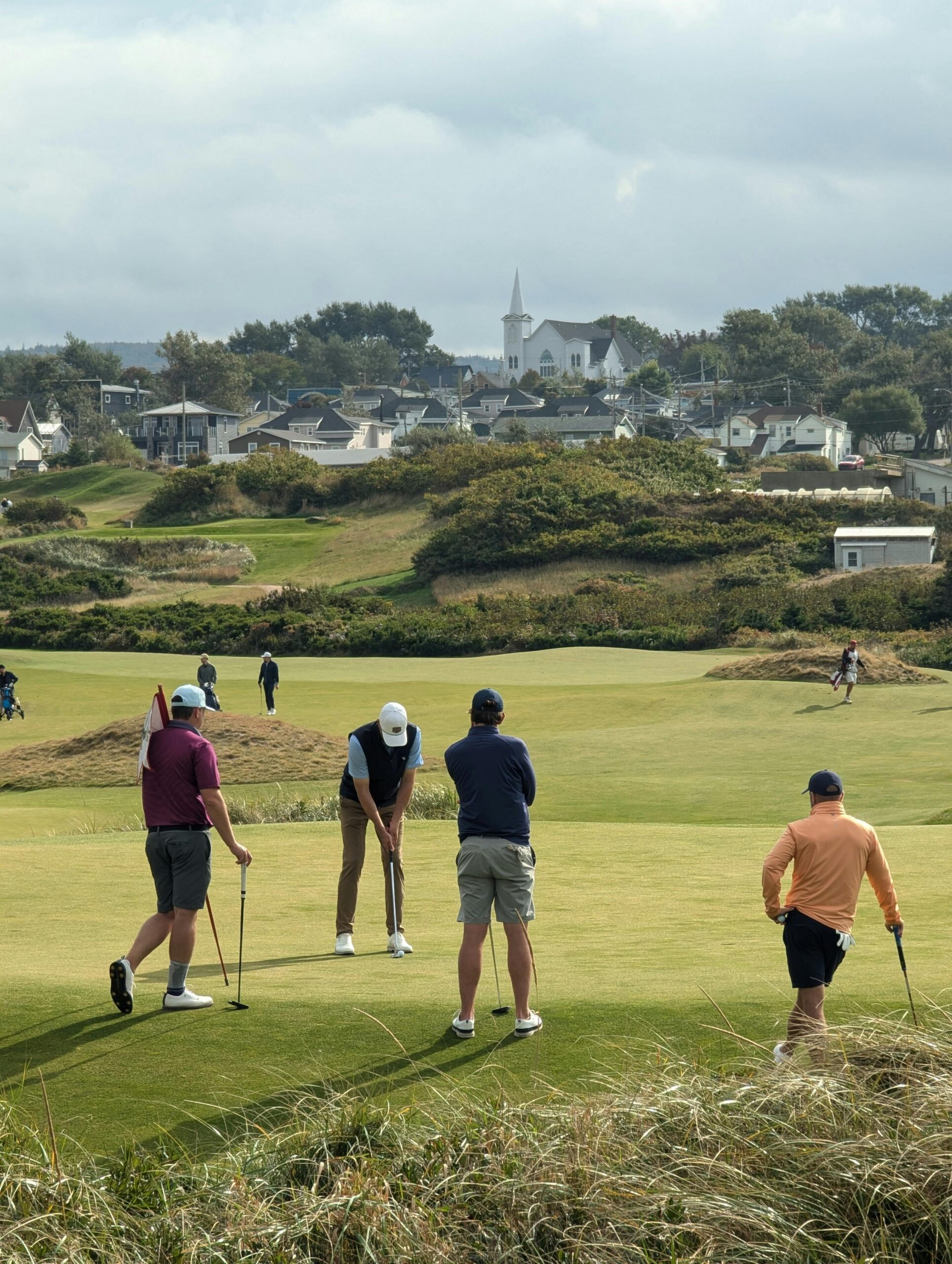 Group of golfers playing on a scenic course in Cape Breton, NS, Canada.
