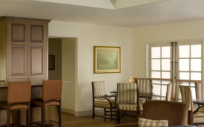 Pebble Beach lodge guest room with seating area and fireplace