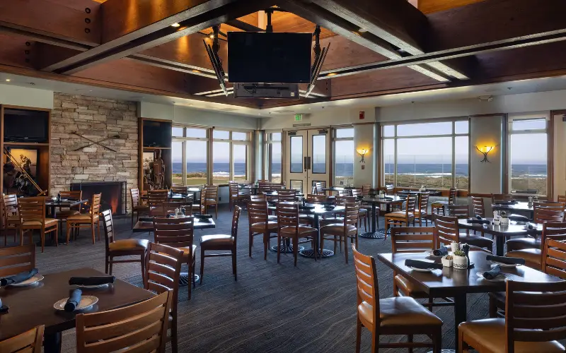 Pebble Beach restaurant dining room with ocean views through large windows