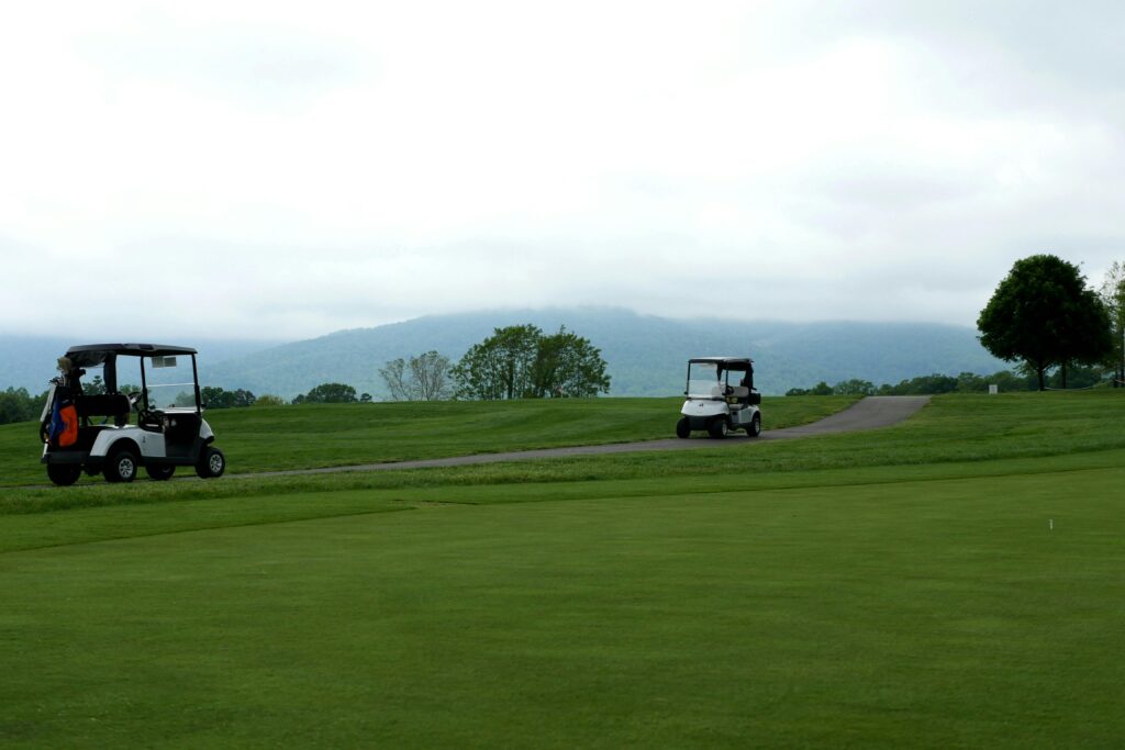 A serene golf course in Crozet, VA featuring golf carts and lush greenery.